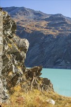 Turquoise lake in the middle of a rocky mountain landscape in autumn, Saas Fee, Switzerland, Europe