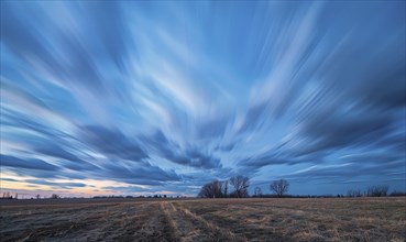 Bright blue sky, wispy cirrus clouds, windy evening AI generated