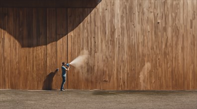 Painting a wooden house with paint from a spray gun, AI generated