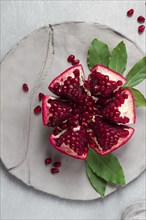 Fresh, cut pomegranate fruit, on a gray background, food concept, top view, no people