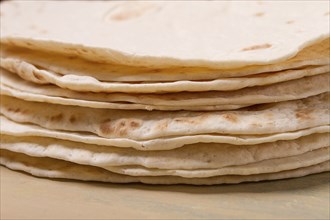 A stack of Mexican tortillas, on a gray table, top view, close-up, no people