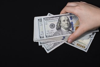 Hand holding American dollar banknotes isolated on white background