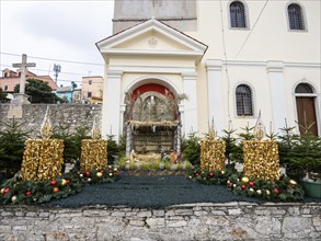 Christmas cot and Advent wreath on the church square, Church of the Nativity of the Virgin Mary,