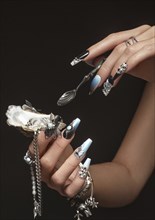 Creative design of nails on female hands. Art manicure. Photo taken in studio