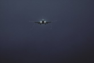 An aircraft lands at blue hour, taken at Berlin Brandenburg Airport 'Willy Brandt'Äô (BER) in