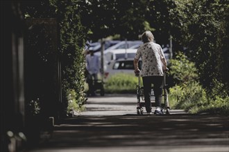 A woman with a rollator, photographed in Berlin, 07/08/2024