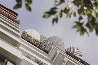 Parasols on the balcony of a prefabricated building, taken in Berlin, 07/08/2024