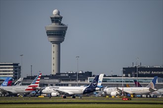 Aircraft at Amsterdam Schiphol Airport, taxiway, apron, air traffic control tower, terminal,