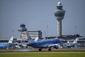 KLM Embraer E175 aircraft landing at Amsterdam Schiphol Airport, Buitenveldertbaan, 09/27, Air