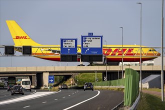 Amsterdam Schiphol Airport, DHL Cargo aircraft on the taxiway, bridge over the A4 motorway,