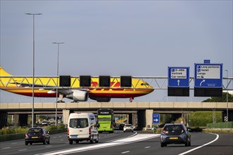 Amsterdam Schiphol Airport, DHL Cargo aircraft on the taxiway, bridge over the A4 motorway,