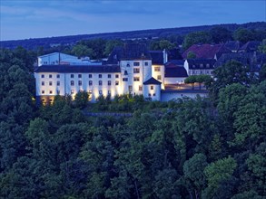 Fürstenberg Castle, a Spornburg, illuminated at night, lies on the Karthagenberg above the Weser