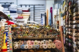 Shop with bales of fabric at the Mercat dels Encants flea market in Barcelona, Spain, Europe