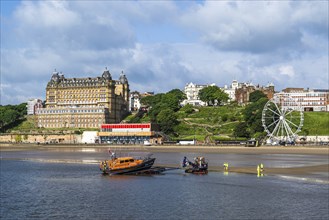 RNLI Scarborough Lifeboat Station and boat over Scarborough Beach, Scarborough, North Yorkshire,