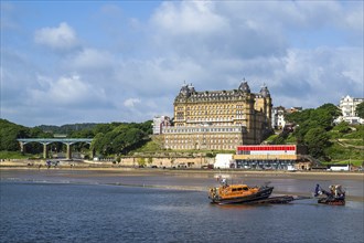 RNLI Scarborough Lifeboat Station and boat over Scarborough Beach, Scarborough, North Yorkshire,