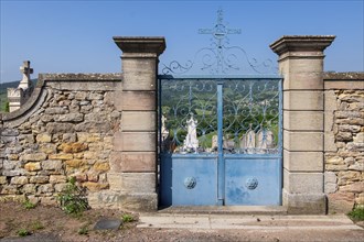 Cemetery wall with a blue entrance gate, Burgundy, France, Europe