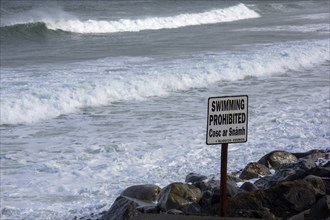 A swimming prohibited sign on a stormy day along the Wild Atlantic Way. Strandhill, Sligo, Ireland,