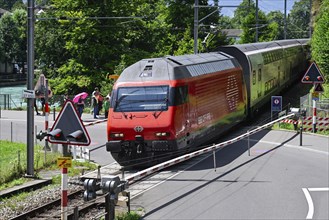 Passenger train railway crossing Barriere, Interlaken, Switzerland, Europe