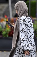 Woman with headscarf and mobile phone