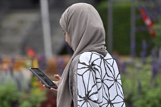 Woman with headscarf and mobile phone