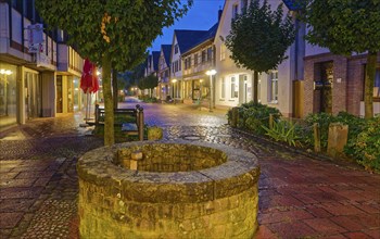 The Münchhausen town of Bodenwerder at night. An old fountain, newly set, in the Grosse Strasse in