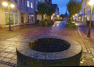 The Münchhausen town of Bodenwerder at night. An old fountain, newly set, in the Grosse Strasse in