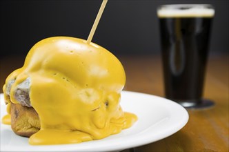 Delicious close-up of hamburger covered in cheddar cheese sauce