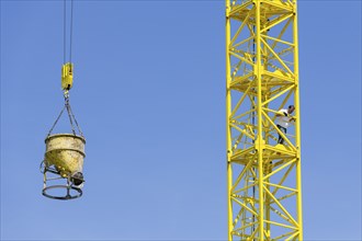 Construction crane with concrete bucket, concrete silo, crane bucket