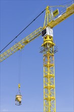 Construction crane with concrete bucket, concrete silo, crane bucket