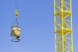 Construction crane with concrete bucket, concrete silo, crane bucket