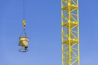 Construction crane with concrete bucket, concrete silo, crane bucket