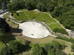 Aerial view of an ancient theatre surrounded by lush greenery and trees, aerial view, amphitheatre,