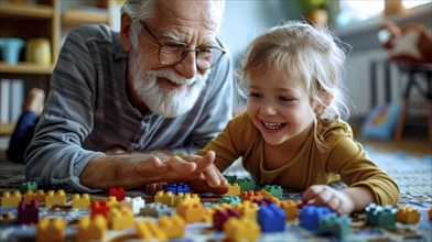 Grandfather and granddaughter smiling while playing with colorful lego blocks on the floor,