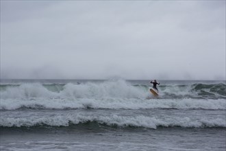 A surfer enjoying the waves on a windy day in the North-West. Strandhill, Sligo, Ireland, Europe