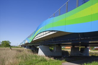 Colourfully painted motorway bridge with noise barrier over the river Este, Buxtehude, Altes Land,