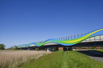 Colourfully painted motorway bridge with noise barrier over the river Este, Buxtehude, Altes Land,