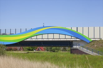 Colourfully painted motorway bridge with noise barrier over the river Este, Buxtehude, Altes Land,