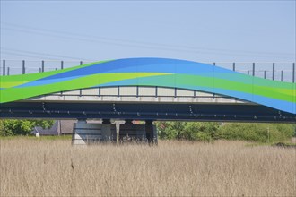 Colourfully painted motorway bridge with noise barrier over the river Este, Buxtehude, Altes Land,