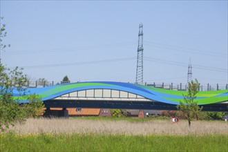 Colourfully painted motorway bridge with noise barrier over the river Este, Buxtehude, Altes Land,