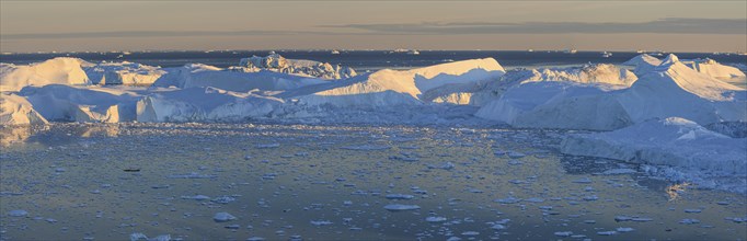 Icebergs reflected in fjord, midnight sun, summer, panorama, Ilulissat Icefjord, Disko Bay, West