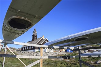 Traditional kayaks on a wooden frame in front of a church, summer, Inuit, Zion's Church, Ilulissat,