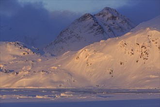 Evening light on snowy mountains, Arctic, Winter, Kulusuk, East Greenland, Greenland, North America