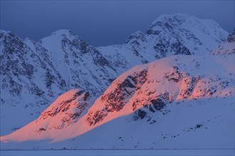 Evening light on snowy mountains, Arctic, Winter, Kulusuk, East Greenland, Greenland, North America