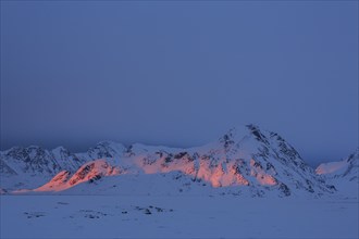 Evening light on snowy mountains, Arctic, Winter, Kulusuk, East Greenland, Greenland, North America