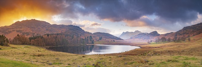 View of Blea Tarn Lake and the Eskdale Valley at sunset, Lake District, Cumbria, England, United