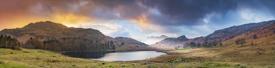 View of Blea Tarn Lake and the Eskdale Valley at sunset, Lake District, Cumbria, England, United