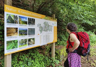 Hiker at an information board about the Mullerthal Nature and Geopark, Mullerthal Trail,