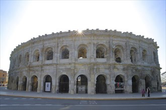 Roman amphitheatre and landmark backlit, Nîmes, Gard, Provence, France, Europe