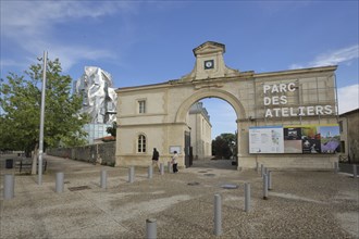 Entrance to the cultural centre with archway and banner to the Parc des Ateliers and Tour Luma,