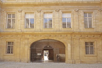 House facade with metal gate and window in the inner courtyard of the town hall, decorations,